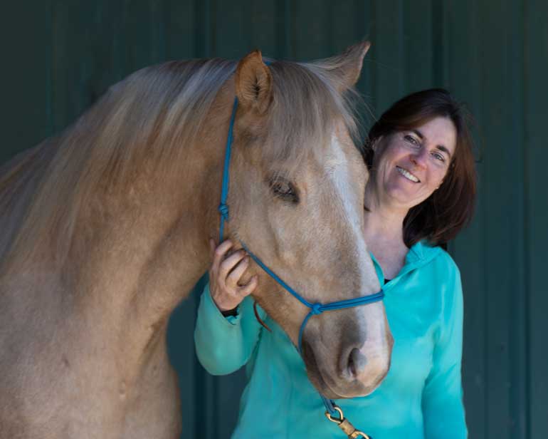 Lori Ackerman with palomino horse